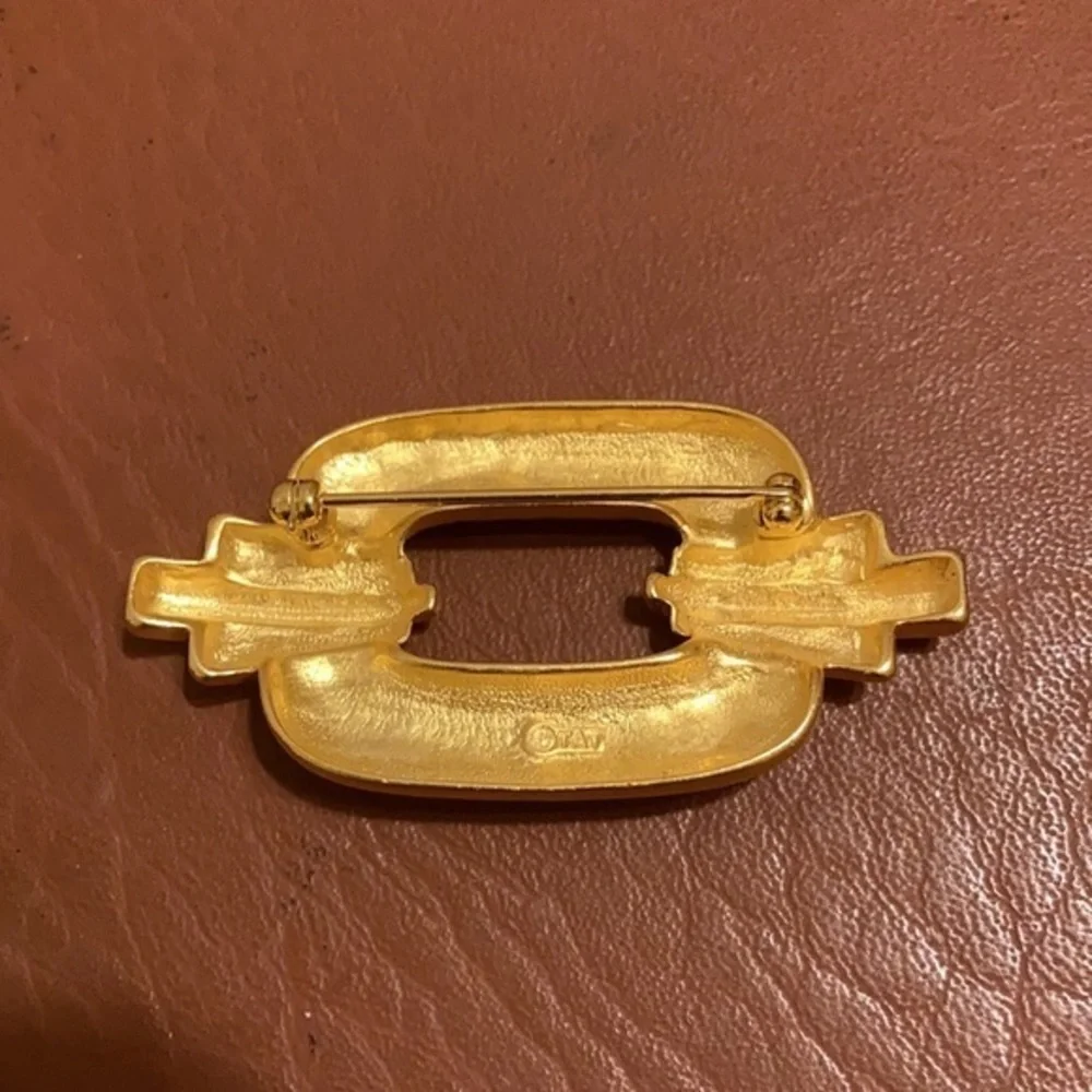 TAT signed gold tone Art Deco style pin
